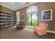 Cozy reading room featuring ample bookshelves, comfortable chairs, and large windows providing natural light at 10797 Tarflower Dr # 202, Venice, FL 34293