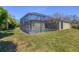 A full backyard view of a screened-in pool and hot tub at 108 Corte Del Asolo, Venice, FL 34285