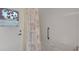 Shower in a bathroom with tiled walls, grab bar, and decorative window at 108 Corte Del Asolo, Venice, FL 34285