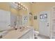 Bathroom with vanity and sink, walk-in shower, and outdoor access at 108 Corte Del Asolo, Venice, FL 34285