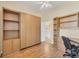 Bright bedroom with built-in shelves, Murphy bed, and wood-look flooring at 108 Corte Del Asolo, Venice, FL 34285