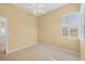 Empty bedroom featuring carpeted floors, closet, and ceiling fan at 108 Corte Del Asolo, Venice, FL 34285