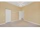 Empty bedroom featuring carpeted floors, closet, and ceiling fan at 108 Corte Del Asolo, Venice, FL 34285