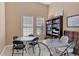 Clubhouse tables and chairs, with bookshelves and a game board at 108 Corte Del Asolo, Venice, FL 34285