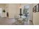 Dining area with tiled flooring, chandelier, and view to the screened-in patio at 108 Corte Del Asolo, Venice, FL 34285