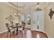 Elegant dining room with decorative lighting, arched windows, and a stylish dining set at 108 Corte Del Asolo, Venice, FL 34285