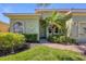 Charming front exterior of home with lush landscaping at 108 Corte Del Asolo, Venice, FL 34285