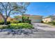 Charming single-story home with a well-manicured lawn and brick driveway under a clear sky at 108 Corte Del Asolo, Venice, FL 34285