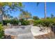 Picturesque community garden featuring lush greenery, benches, and tranquil pathways at 108 Corte Del Asolo, Venice, FL 34285