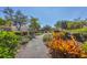 Lush landscaping and a paved walkway that adds beautiful curb appeal to the home and community at 108 Corte Del Asolo, Venice, FL 34285