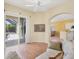 Inviting living room featuring sliding glass doors to a screened-in lanai and a glimpse of the kitchen at 108 Corte Del Asolo, Venice, FL 34285