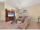 Living room featuring neutral walls, ceiling fan, tile floors, and a view to outside at 108 Corte Del Asolo, Venice, FL 34285