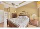 A primary bedroom with decorative ceiling, hardwood flooring and ensuite bathroom at 108 Corte Del Asolo, Venice, FL 34285