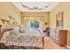 The main bedroom features a ceiling fan, wood floors, and sliding glass door to the pool at 108 Corte Del Asolo, Venice, FL 34285