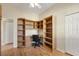Office with built-in shelving, desk, and wood-look floors at 108 Corte Del Asolo, Venice, FL 34285