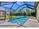 Screened in pool and patio area overlooking palm trees and lush vegetation at 108 Corte Del Asolo, Venice, FL 34285
