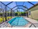 A screened in private pool surrounded by patio and lush vegetation at 108 Corte Del Asolo, Venice, FL 34285