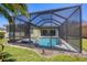 Backyard view of a screened-in pool and hot tub at 108 Corte Del Asolo, Venice, FL 34285