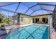 Backyard swimming pool with hot tub, screened-in lanai, and blue water at 108 Corte Del Asolo, Venice, FL 34285
