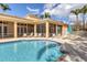 Stunning community pool surrounded by lounge chairs and lush landscaping at 108 Corte Del Asolo, Venice, FL 34285