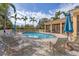 Relaxing poolside with ample lounge chairs and shade in a tropical setting at 108 Corte Del Asolo, Venice, FL 34285