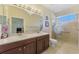 Bathroom boasting a double sink vanity, glass shower doors, and a spacious layout at 11157 Batello Dr, Venice, FL 34292
