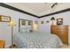 Charming bedroom featuring a ceiling fan, black trim, and decorative wall art at 11157 Batello Dr, Venice, FL 34292