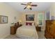 Bedroom with a ceiling fan and bright window at 11157 Batello Dr, Venice, FL 34292