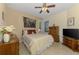 Bedroom featuring a ceiling fan, window, and neutral paint at 11157 Batello Dr, Venice, FL 34292