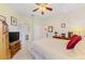 Bedroom featuring neutral walls, a ceiling fan, and wood furnishings with a tile floor at 11157 Batello Dr, Venice, FL 34292