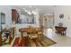 Dining area with wood table with view to entryway with tile flooring and natural light at 11157 Batello Dr, Venice, FL 34292
