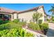 Side exterior view of the home showing landscaping and screened-in patio at 11157 Batello Dr, Venice, FL 34292