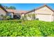 Lush landscaping surrounds this beautiful single-story home and enclosed patio at 11157 Batello Dr, Venice, FL 34292