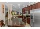 Kitchen features granite counters, stainless appliances, and an eat-in table at 11157 Batello Dr, Venice, FL 34292