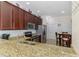 Kitchen area featuring granite countertops, stainless steel appliances, and casual dining space at 11157 Batello Dr, Venice, FL 34292