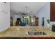 Open kitchen features granite countertops and view into the living room at 11157 Batello Dr, Venice, FL 34292