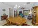 Open living area with tile flooring and view from dining area to patio at 11157 Batello Dr, Venice, FL 34292