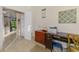 Office area with a desk, printer, and a calendar, featuring a tiled floor at 11157 Batello Dr, Venice, FL 34292