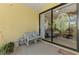 Covered patio area with sliding doors and a glimpse of the lush backyard at 11157 Batello Dr, Venice, FL 34292