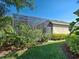 Exterior view of the screened-in pool and lush landscaping at 117 Altesino Ct, Venice, FL 34292
