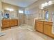 Bathroom featuring a glass-enclosed shower, double sinks, and ample cabinet space at 117 Altesino Ct, Venice, FL 34292