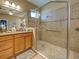 Bright bathroom featuring a glass-enclosed shower and vanity with granite countertops at 117 Altesino Ct, Venice, FL 34292