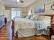 View of bedroom with hardwood floors and a sliding glass door to patio at 117 Altesino Ct, Venice, FL 34292