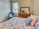 Cozy bedroom with wood floors, a plush bed, and a spacious closet at 117 Altesino Ct, Venice, FL 34292