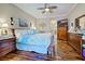 Well-lit bedroom with hardwood floors and a large dresser with a TV at 117 Altesino Ct, Venice, FL 34292