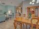 Inviting dining area with a classic wooden table and chairs, seamlessly connecting to the cozy living room at 117 Altesino Ct, Venice, FL 34292