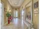 Grand foyer with decorative tile flooring, ornate mirror, and elegant decor leading into various living spaces at 117 Altesino Ct, Venice, FL 34292