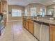 Bright kitchen featuring stainless steel appliances, granite counters, ample natural light, and a seamless flow to the outdoor area at 117 Altesino Ct, Venice, FL 34292