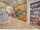 Kitchen with stainless appliances, wooden cabinets, granite counters, and view to the dining room at 117 Altesino Ct, Venice, FL 34292