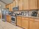 This kitchen shows light wood cabinets, stainless steel appliances, and a tile backsplash at 117 Altesino Ct, Venice, FL 34292